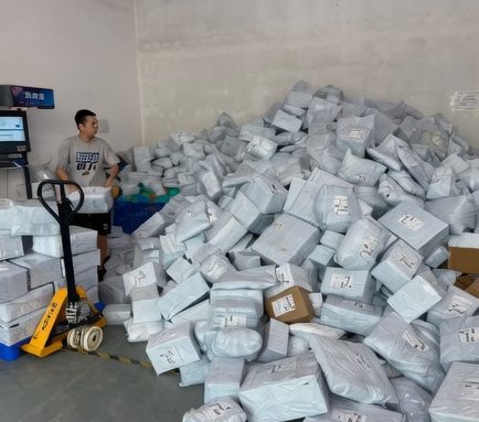 China warehouse worker with parcels ready for air DDP